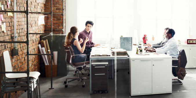 4 team members sitting in a conference room